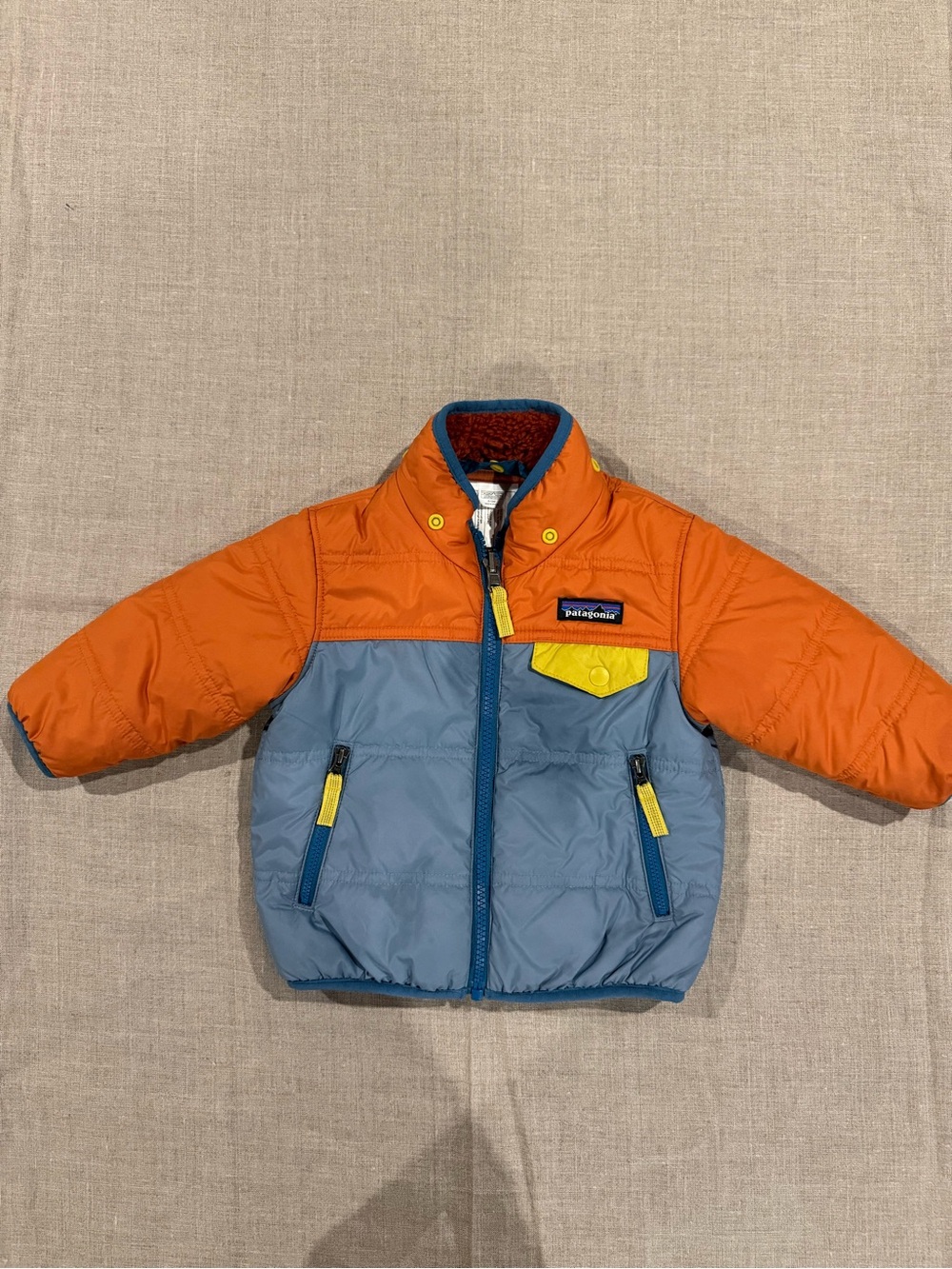 Patagonia Baby Insulated Jacket, Size 6–12M — Bright orange and blue with yellow